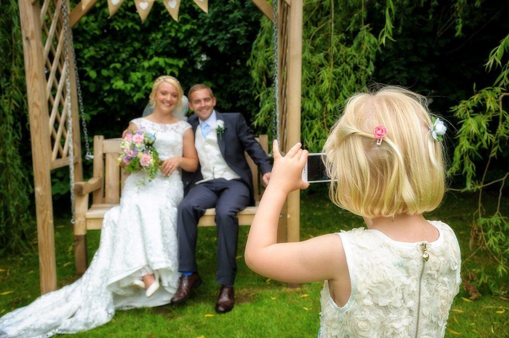 bristol-wedding-photographer5 Flower girl taking photo of bride and groom