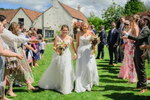 same-sex LGBTQ+ Wedding Photography - two brides and confetti