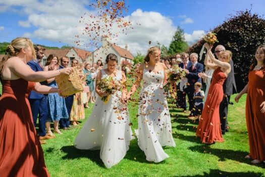 same-sex LGBTQ+ Wedding Photography - two brides and confetti